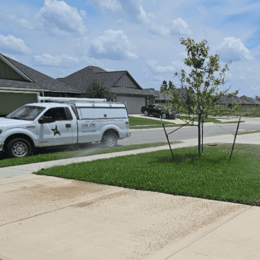 Lone Star Property Services irrigation service truck parked at a customer's home